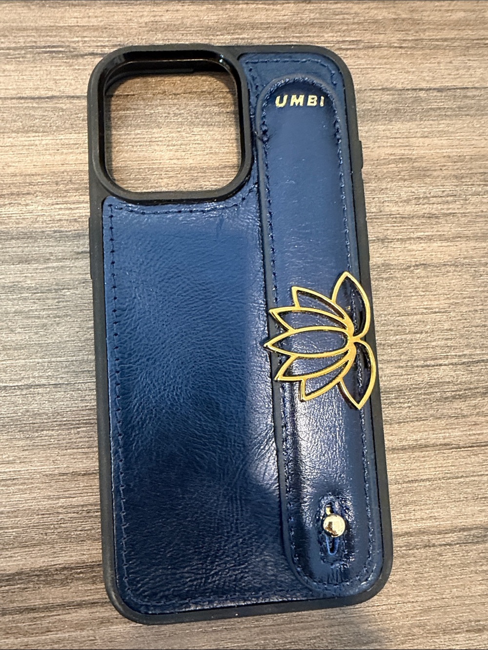 UMBI leather case for iPhone 13/14 Pro with lotus gold accent.